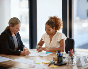 Two people in an office having a discussion.