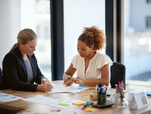 Two people in an office having a discussion.