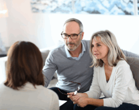 Image of a senior couple consulting with an advisor.