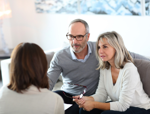Image of a senior couple consulting with an advisor.