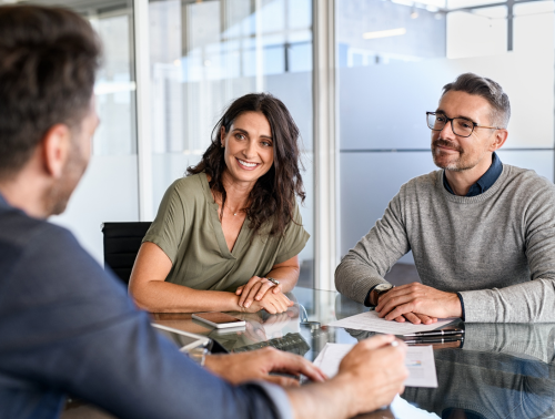 A couple meeting with an advisor, representing the idea of preparing a ‘to-do’ list for making your will.