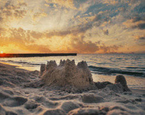 Sand castle on empty beach.