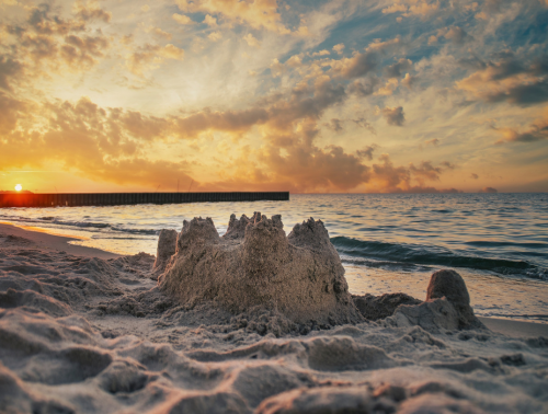 Sand castle on empty beach.
