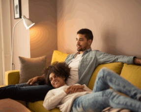 Image of a couple sitting on a sofa, representing cohabitation agreements.