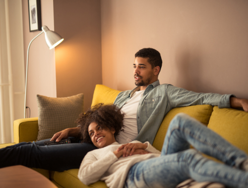 Image of a couple sitting on a sofa, representing cohabitation agreements.