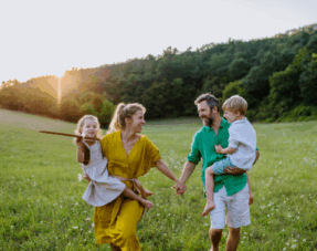 Image of a happy family in a field.