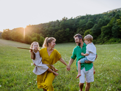 Image of a happy family in a field.